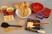 Group shot of all items including scale, mugs, wooden spoons, colanders, containers and utensils