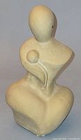 Front view of beige modernist mother and baby figurine