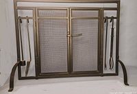 Front view of fireplace screen with tools hanging