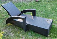 Side view of woven resin wicker chaise showing length, arm shape and adjustable backrest