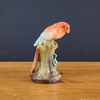 Front view of ceramic parakeet bud vase on stump