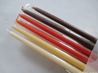 Open end of box showing cream, terracotta and brown slim candles