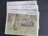 Front view of all three books showing titles and illustrated dust jackets