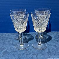 Four Waterford Alana crystal claret goblets standing upright