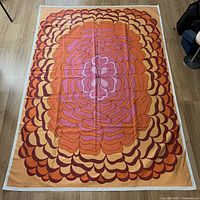 Full view of Almedahls op-art tablecloth laid flat showing overall pattern and white border