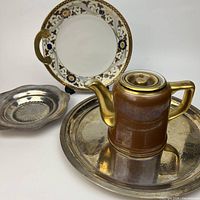 Group view of Noritake plate, Hall teapot, silver plated tray and dish