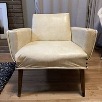 Front view of cream vinyl lounge chair showing overall form
