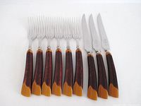 Six forks and three steak knives with faux antler handles