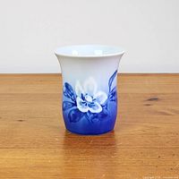 Front view of blue and white Bing & Grondahl Christmas Rose porcelain bud vase