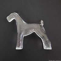 Front view of clear glass Airedale Terrier paperweight showing overall form and texture