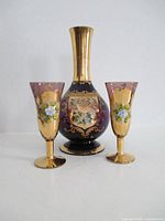 Front view decanter and two glasses showing design and scale