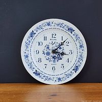 Front view of Bulova blue and white plate wall clock