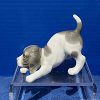 full side view of grey and white porcelain puppy figurine