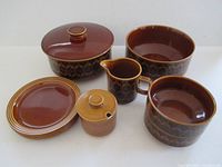 All pottery pieces grouped: casseroles, bowls, plates, creamer, jam jar