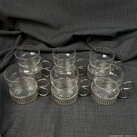six glass cups in nickel-plated holders