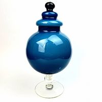 Full view of blue lidded vase showing foot, body, lid