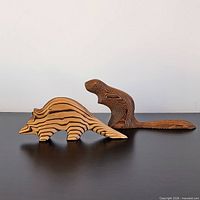 Both Gerd Untermann wooden carvings side by side, beaver and raccoon visible