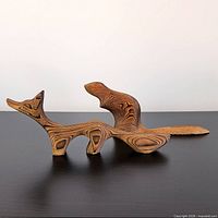 Side view of wooden fox sculpture showing grain pattern and form