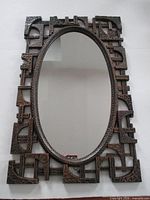 Front view of entire brutalist oval mirror