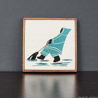 Front view of tile plaque showing Inuit artwork and wood frame