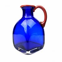 Front view of cobalt blue jug with red handle and lip