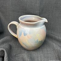Front view of pastel glazed studio pottery pitcher