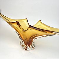 Oblique view showing amber freeform bowl profile and clear base