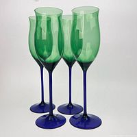 Four green-bowl, cobalt blue-stem Mikasa Lido wine glasses standing side by side