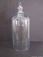 Full view of clear glass cloche standing upright