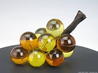 Side view showing amber and yellow lucite grapes and faux wood stem