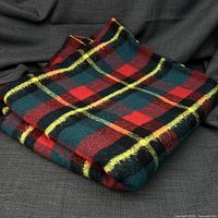 Folded tartan blanket showing pattern and texture