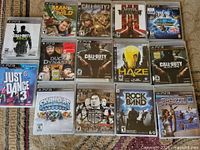 All 14 PS3 game cases laid out in four rows