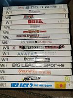 Stack of 15 Wii game cases showing spines
