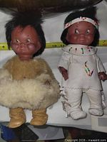 Front view of both 12" Regal dolls showing outfits and size reference tape