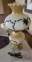 Full view of Carl Falkenstein electric hurricane lamp with cord and ornate base