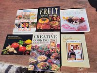 Front covers of six cookbooks laid out