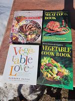 Front covers of four hardcover cookbooks