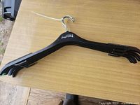 Stack of black Joseph Ribkoff hangers showing overall shape