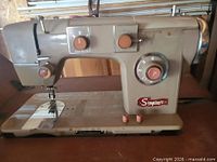 Front view of Simpson's sewing machine showing badge and controls