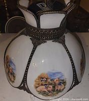 Full view of glass lamp showing farm motif panels