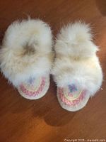 top view showing fur collar and beaded vamp of both moccasins
