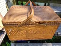 Closed hamper showing woven rattan sides, handles, blemish