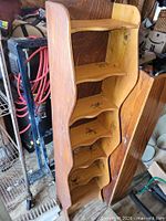 Full view of tall wooden shelving showing side profile and shelves