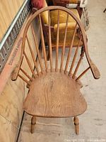 Front view of Windsor armchair showing spindle back and seat