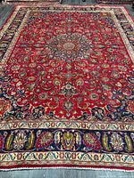 Full rug showing central medallion and complete border