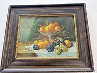 Front view of framed oil still life painting