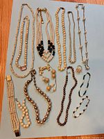 All jewellery pieces laid out on blue background showing variety and count