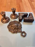 overview of candlesticks, hand mirror and bookends on surface