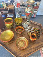 Group shot showing all painted wooden items and utensils on tray