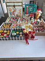 Overall view showing trunk, multiple ornament boxes, plush elves and reindeer